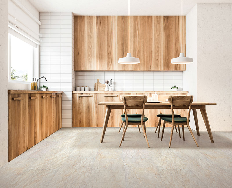 luxury vinyl tile in kitchen with wood cabinets and wood dining table